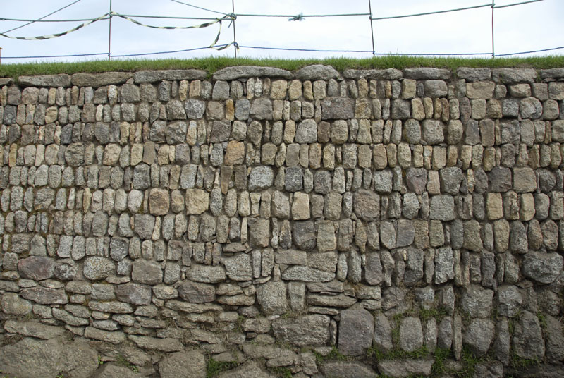 Close up photo of the outside wall of the Plain-an-Gwarry showing the repair works